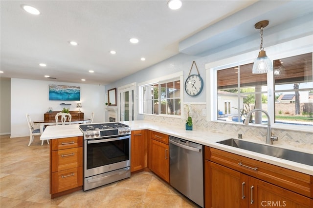 1225 Old Hickory Rd, Corona, CA 92882 - kitchen featuring appliances with stainless steel finishes, a peninsula, recessed lighting, brown cabinetry, and tasteful backsplash