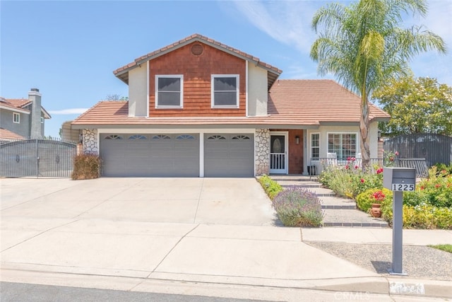 1225 Old Hickory Rd, Corona, CA 92882 - traditional home featuring a garage, a gate, stone siding, and concrete driveway