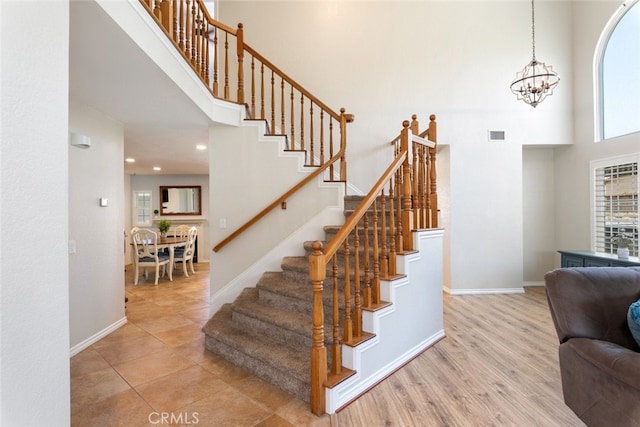 1225 Old Hickory Rd, Corona, CA 92882 - staircase featuring a high ceiling, a chandelier, and recessed lighting