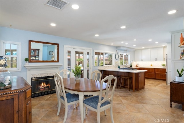 1225 Old Hickory Rd, Corona, CA 92882 - dining area with plenty of natural light, a glass covered fireplace, recessed lighting, and light tile patterned flooring
