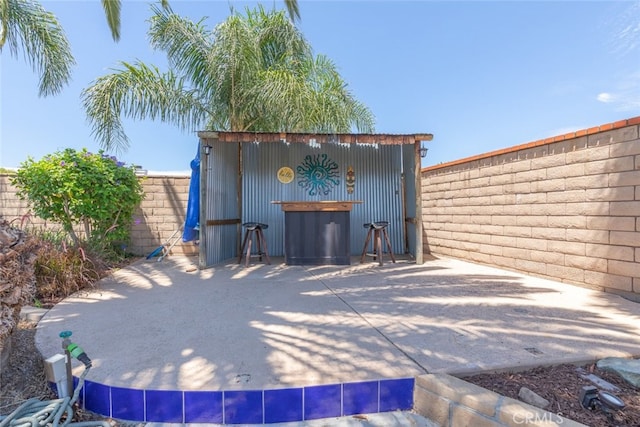 1225 Old Hickory Rd, Corona, CA 92882 - fenced backyard featuring an outdoor structure and a patio