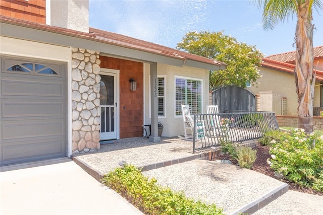 1225 Old Hickory Rd, Corona, CA 92882 - view of exterior entry featuring a garage, stucco siding, and a gate