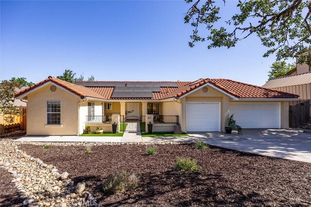 215 Meadowlark Rd, Paso Robles, CA 93446 - view of front of house featuring a garage, a gate, a tiled roof, driveway, and roof mounted solar panels