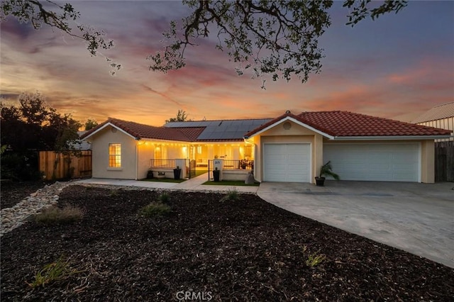 215 Meadowlark Rd, Paso Robles, CA 93446 - single story home featuring an attached garage, solar panels, a tiled roof, concrete driveway, and stucco siding