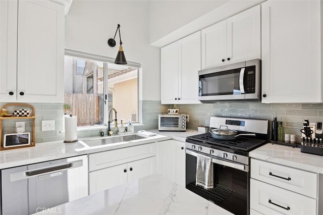 215 Meadowlark Rd, Paso Robles, CA 93446 - kitchen with appliances with stainless steel finishes, white cabinets, light stone countertops, and backsplash