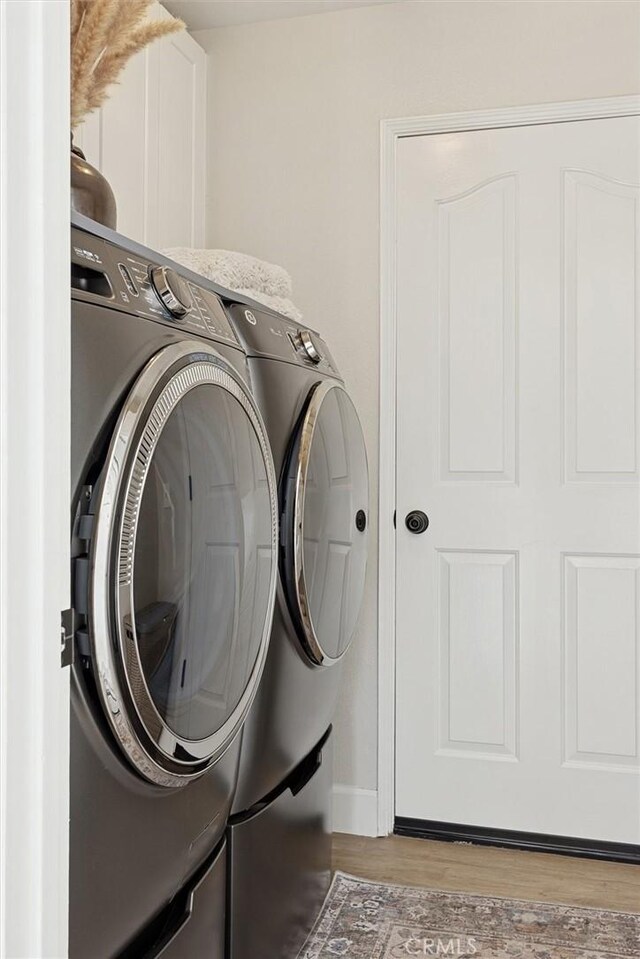 215 Meadowlark Rd, Paso Robles, CA 93446 - laundry room with separate washer and dryer, light wood finished floors, and cabinet space