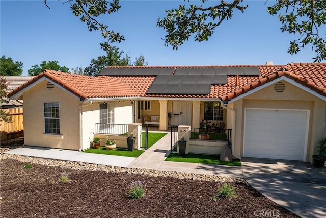 215 Meadowlark Rd, Paso Robles, CA 93446 - mediterranean / spanish-style house featuring a porch, a garage, driveway, roof mounted solar panels, and a tile roof