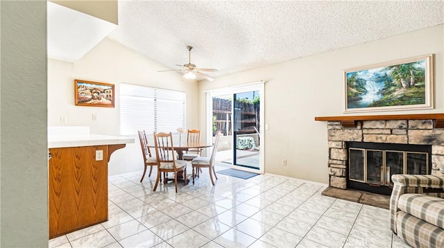 7339 Greenbriar Pl, Rancho Cucamonga, CA 91730 - dining space featuring a textured ceiling, a ceiling fan, lofted ceiling, light marble finish floors, and a fireplace