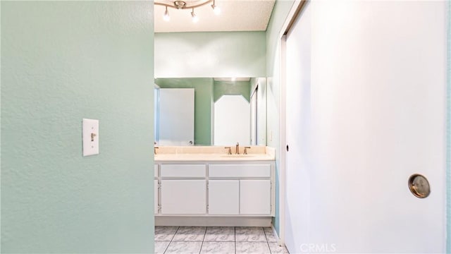7339 Greenbriar Pl, Rancho Cucamonga, CA 91730 - full bathroom with double vanity, a textured wall, and marble finish floors