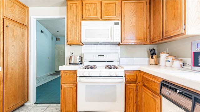7339 Greenbriar Pl, Rancho Cucamonga, CA 91730 - kitchen with white appliances, tile countertops, and brown cabinets