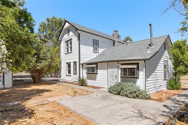 2725 W Sacramento Ave, Chico, CA 95973 - view of front of property featuring a shingled roof, a chimney, and a patio area