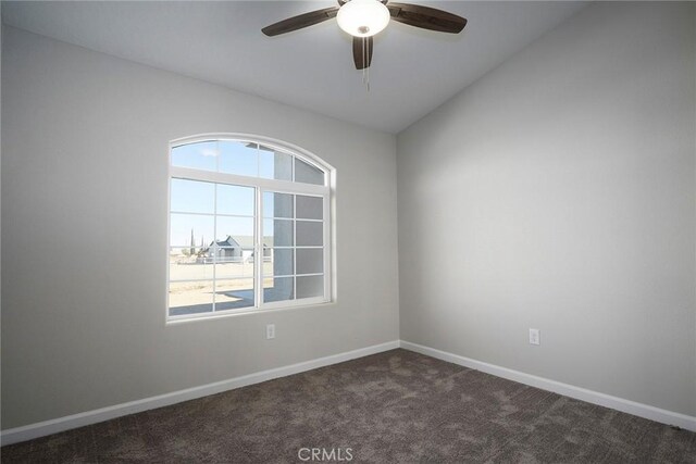 18238 Talisman St, Hesperia, CA 92345 - spare room featuring dark colored carpet, ceiling fan, and vaulted ceiling