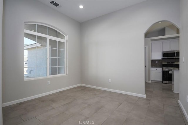 18238 Talisman St, Hesperia, CA 92345 - unfurnished room featuring arched walkways, recessed lighting, and light tile patterned floors