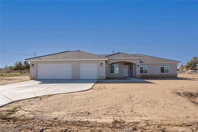 18238 Talisman St, Hesperia, CA 92345 - ranch-style house with a garage, driveway, a tiled roof, and stucco siding