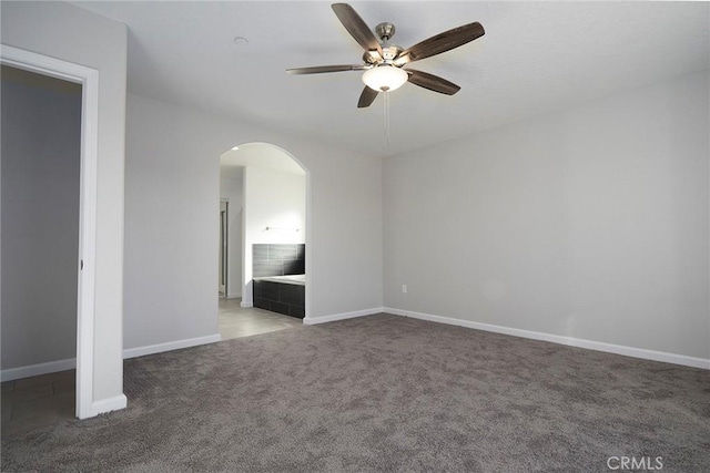 18238 Talisman St, Hesperia, CA 92345 - carpeted empty room featuring arched walkways and a ceiling fan