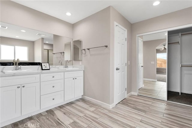 18420 Wisteria St, Hesperia, CA 92345 - bathroom featuring double vanity, wood finished floors, and recessed lighting