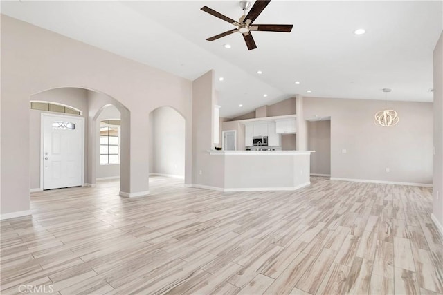 18420 Wisteria St, Hesperia, CA 92345 - unfurnished living room featuring a ceiling fan, light wood-style flooring, high vaulted ceiling, arched walkways, and recessed lighting
