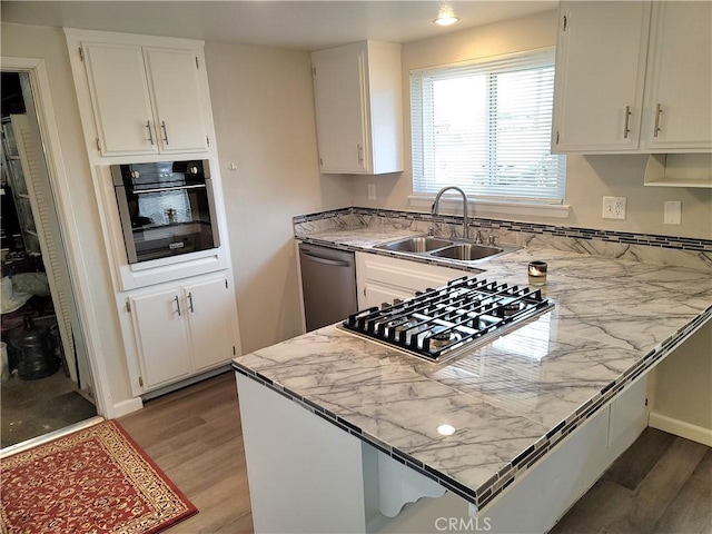 15420 Apache Rd, Apple Valley, CA 92307 - kitchen featuring appliances with stainless steel finishes, a peninsula, light wood-type flooring, white cabinets, and recessed lighting