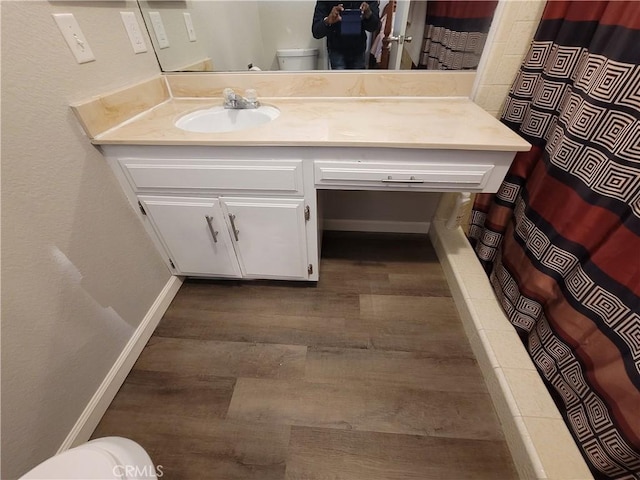 15420 Apache Rd, Apple Valley, CA 92307 - full bathroom featuring wood finished floors, vanity, and a shower with shower curtain