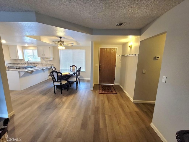 15420 Apache Rd, Apple Valley, CA 92307 - dining space featuring light wood finished floors, a textured ceiling, and a ceiling fan
