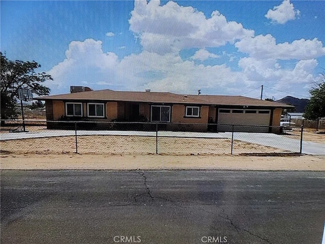 15420 Apache Rd, Apple Valley, CA 92307 - view of front of property with a garage, concrete driveway, and a fenced front yard