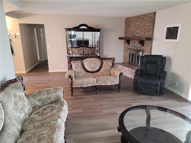 15420 Apache Rd, Apple Valley, CA 92307 - living room featuring wood finished floors and a fireplace