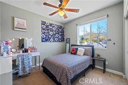 11126 Whitebark Ln, Corona, CA 92883 - carpeted bedroom featuring a desk and ceiling fan