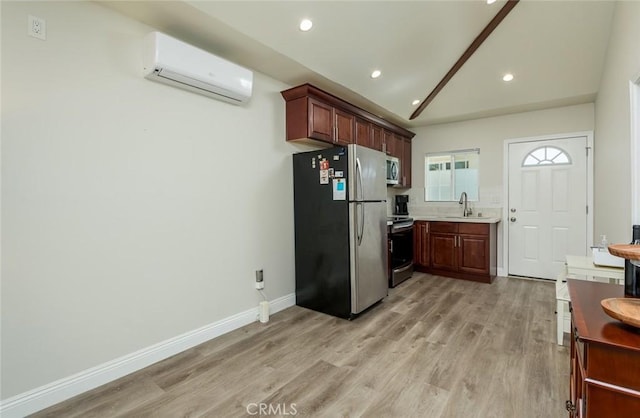 11162 Barman Ave, Culver City, CA 90230 - kitchen with appliances with stainless steel finishes, an AC wall unit, light countertops, light wood-type flooring, and recessed lighting
