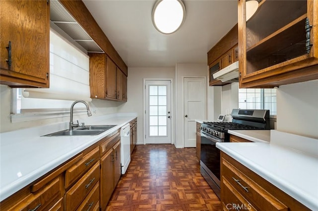 11162 Barman Ave, Culver City, CA 90230 - kitchen with stainless steel gas stove, under cabinet range hood, light countertops, brown cabinetry, and plenty of natural light