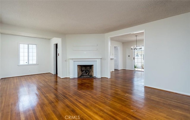 11162 Barman Ave, Culver City, CA 90230 - unfurnished living room with a chandelier, wood finished floors, a fireplace, and a textured ceiling