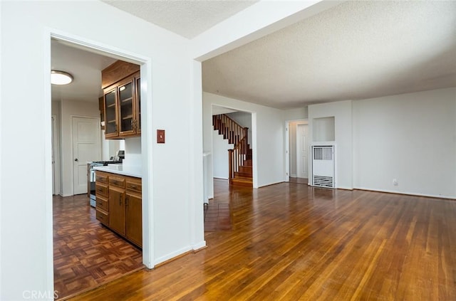 11162 Barman Ave, Culver City, CA 90230 - unfurnished living room featuring stairs, dark wood-style floors, and a textured ceiling