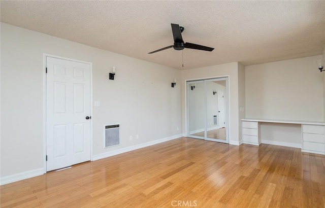11162 Barman Ave, Culver City, CA 90230 - empty room with ceiling fan, light wood-style flooring, a textured ceiling, built in study area, and heating unit