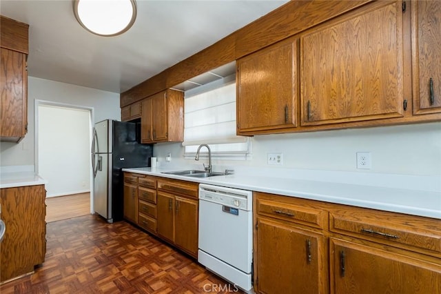 11162 Barman Ave, Culver City, CA 90230 - kitchen with dishwasher, brown cabinetry, freestanding refrigerator, and light countertops