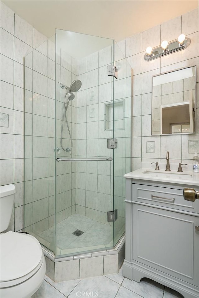 11162 Barman Ave, Culver City, CA 90230 - full bathroom featuring tile walls, vanity, a shower stall, and tile patterned flooring