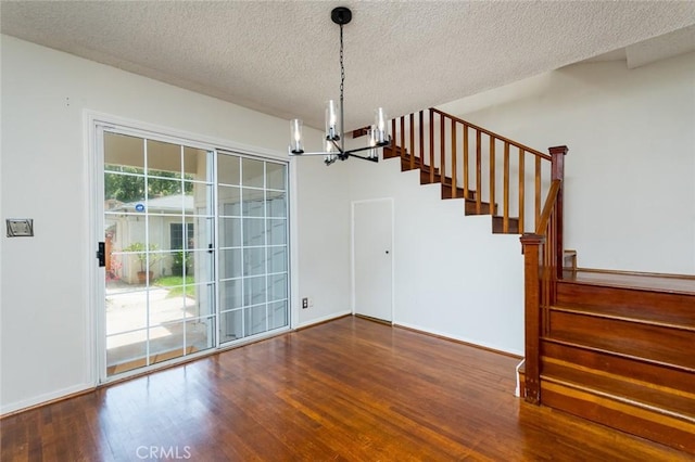 11162 Barman Ave, Culver City, CA 90230 - unfurnished dining area featuring a chandelier, stairs, wood finished floors, and a textured ceiling
