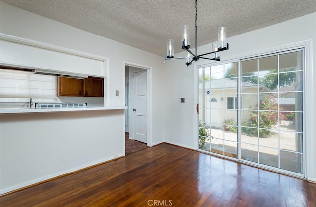 11162 Barman Ave, Culver City, CA 90230 - unfurnished dining area featuring a chandelier, a textured ceiling, and dark wood finished floors