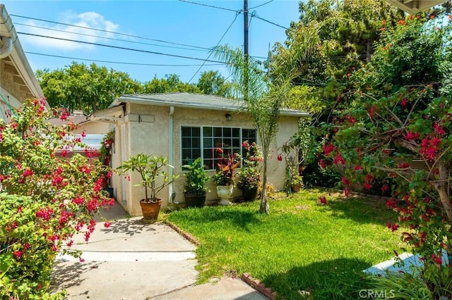 11162 Barman Ave, Culver City, CA 90230 - exterior space featuring stucco siding, an outbuilding, and a lawn