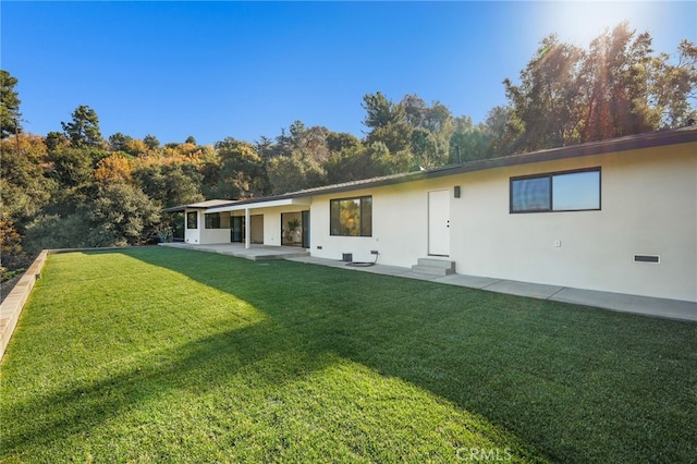 2115 E Santiago St, Covina, CA 91724 - rear view of property featuring a yard, a patio, and stucco siding