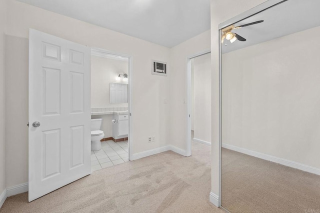 3423 Del Este Way, Oceanside, CA 92056 - unfurnished bedroom featuring light carpet, a closet, ensuite bath, light tile patterned floors, and a ceiling fan