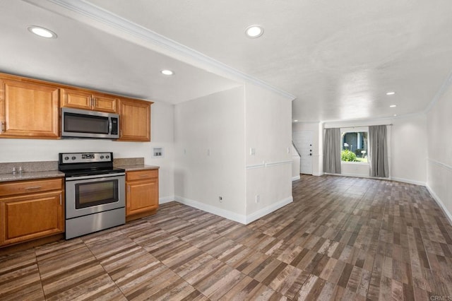 3423 Del Este Way, Oceanside, CA 92056 - kitchen with appliances with stainless steel finishes, crown molding, recessed lighting, brown cabinetry, and wood finished floors