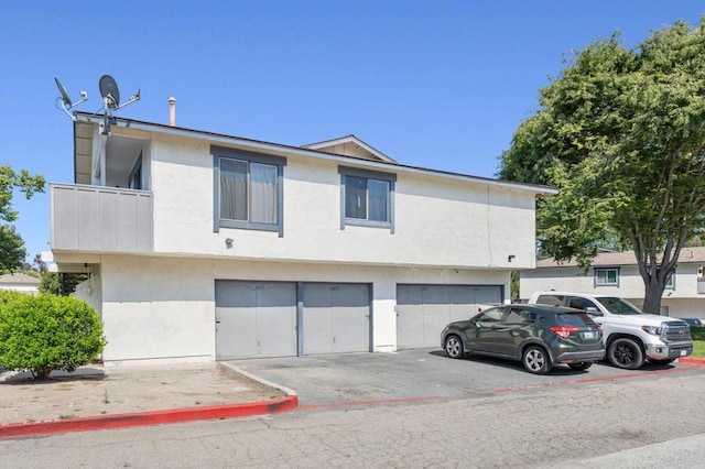 3423 Del Este Way, Oceanside, CA 92056 - view of front of property with an attached garage, asphalt driveway, and stucco siding