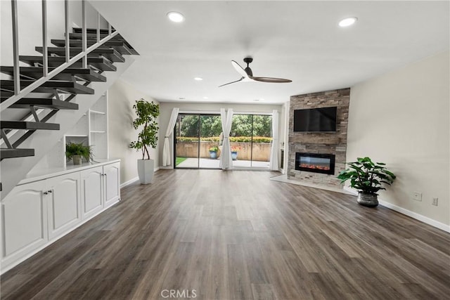 1346 Tourney Hill Ln Unit 67, Nipomo, CA 93444 - unfurnished living room featuring a ceiling fan, a stone fireplace, dark wood-style floors, recessed lighting, and stairway