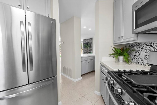 1346 Tourney Hill Ln Unit 67, Nipomo, CA 93444 - kitchen with stainless steel appliances, light tile patterned floors, recessed lighting, and tile countertops