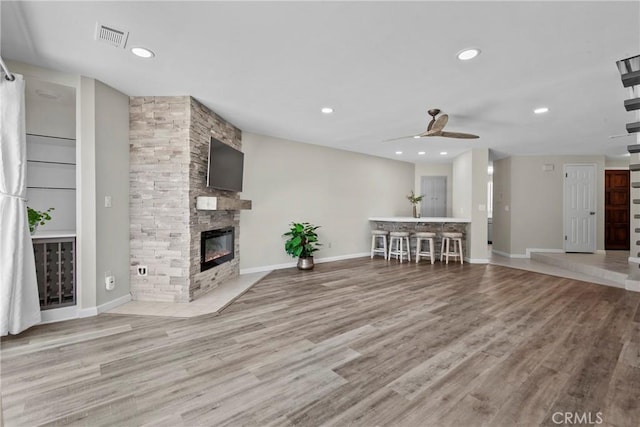 1346 Tourney Hill Ln Unit 67, Nipomo, CA 93444 - living area featuring a ceiling fan, wood finished floors, a stone fireplace, and recessed lighting