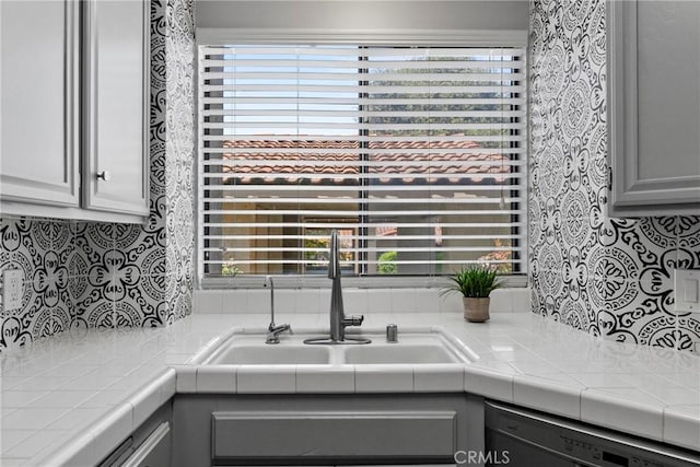 1346 Tourney Hill Ln Unit 67, Nipomo, CA 93444 - kitchen featuring dishwasher, backsplash, tile counters, and healthy amount of natural light