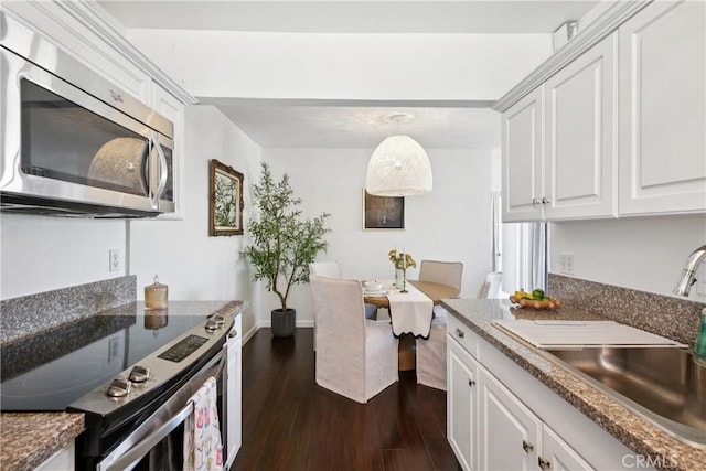 2704 Voorhees Ave Unit 4, Redondo Beach, CA 90278 - kitchen with appliances with stainless steel finishes, dark wood-style flooring, and white cabinets
