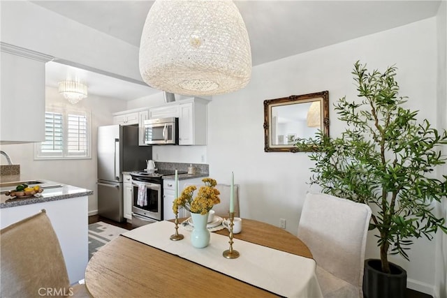 2704 Voorhees Ave Unit 4, Redondo Beach, CA 90278 - dining space featuring a chandelier and dark wood-type flooring
