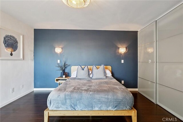 2704 Voorhees Ave Unit 4, Redondo Beach, CA 90278 - bedroom featuring an accent wall and wood finished floors