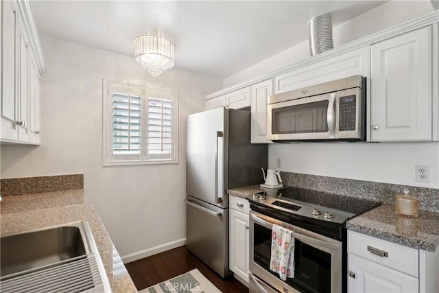 2704 Voorhees Ave Unit 4, Redondo Beach, CA 90278 - kitchen with appliances with stainless steel finishes, white cabinetry, and dark wood-type flooring