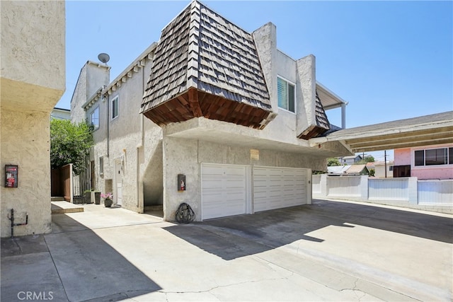 2704 Voorhees Ave Unit 4, Redondo Beach, CA 90278 - view of building exterior featuring driveway and a garage